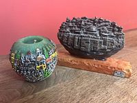 Candle and silver-plated relief side by side showing scale and details