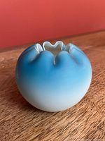 Side view showing ombre blue satin glass body and ruffled rim