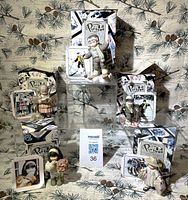 All five Enesco Kim Anderson pieces with boxes and photo cards displayed