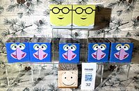 Front view showing 2 Honeydew, 5 Gonzo, 1 Pigpen Cubeez tins