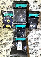 All five sealed Nightmare Before Christmas tablecloth packages displayed
