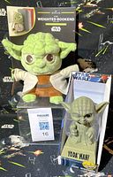 Both Yoda items: plush weighted bookend in package and bobblehead boxed