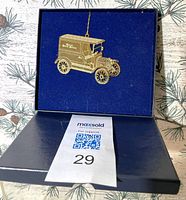 Ornament displayed inside original blue box showing truck design and hanging cord