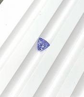 Trillion-cut tanzanite on white ridged background