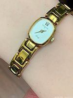 Front view of watch on wrist showing dial and bracelet