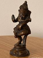 Front view of brass Ganesha figurine