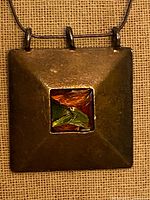 Front view of pendant showing dichroic glass and silver surface