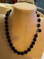 Full view of necklace on display bust showing bead strand and length