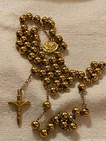 Full view of rosary showing beads, centerpiece and crucifix