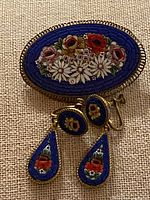 Front view of brooch and earrings showing mosaic design
