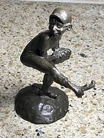 Front-left view of bronze pitcher sculpture