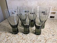 Front view of six smoke grey Holmegaard Canada wine glasses