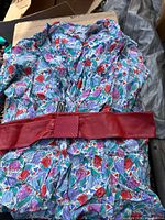 Full view of floral dress with belt laid out