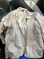 Full view of cream wool coat showing front buttons and lapels