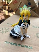 Front angled view of kneeling anime maid figure