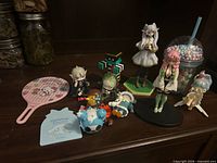 Group shot of all anime figures and Sanrio accessories on shelf