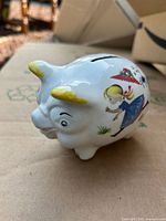 Left side view showing girl illustration and coin slot