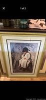 Full view of framed print leaning against surface