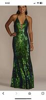 Front view of iridescent green and blue sequin halter gown on model
