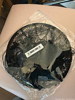Dreamcatcher in plastic packaging showing hoop and crochet centre