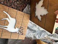 Wood plaques showing maple leaf and deer cut-out designs