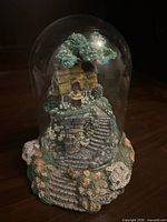 Full view of glass dome with cottage diorama inside