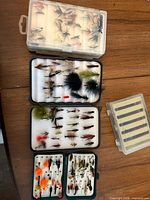 overview of four fly boxes filled with various fishing flies
