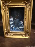 Front view of gold-tone framed illuminated diorama with Sorcerer Mickey scene