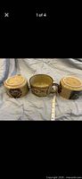 Three stoneware soup mugs showing exterior decoration and size reference