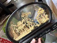 Full view of cork diorama within oval glass case and wooden base