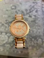 Front view of Michael Kors watch showing dial, bezel, bracelet