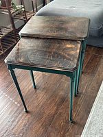 Two rectangular nesting tables, smaller nested under larger