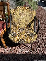 Front view of vintage upholstered armchair with patterned fabric