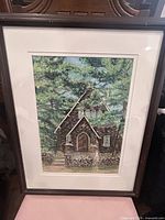Full view of framed pastel artwork depicting stone chapel