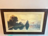 Full view of framed coastal painting on wall