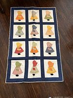 Full view of Sunbonnet Sue quilt showing pattern and size