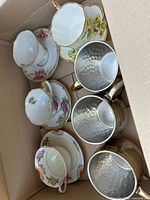 Box with three teacup & saucer sets and three hammered copper mugs