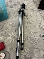 Full view of folded Vivitar aluminum tripod showing legs, locks and head