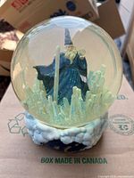 Full view of wizard snow globe showing figure and crystal details