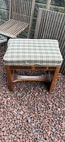 full view of bench, plaid cushion, wood frame