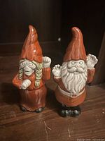 Front view of two zombie gnome figurines