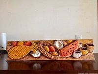 front view of carved wood still-life panel