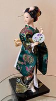 Front view of geisha doll on stand