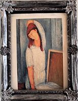 Ornate metal frame with print of seated woman, portrait orientation