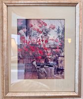 Framed print of geraniums and watering cans under glass