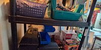 Shelf with toolboxes, plastic bins, boxed power tools