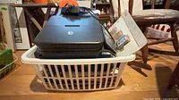 HP Photosmart 7520 printer in laundry basket with calendars