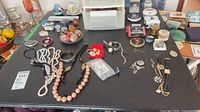 Overview of all jewelry, eggs, ceramics, watches on table