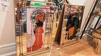 Two of three framed mirrors showing Art Nouveau illustrations, gold-tone frames