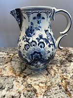 Pitcher side view showing floral pattern and handle